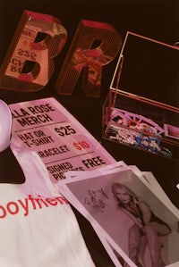 a pink t - shirt and other items on a table